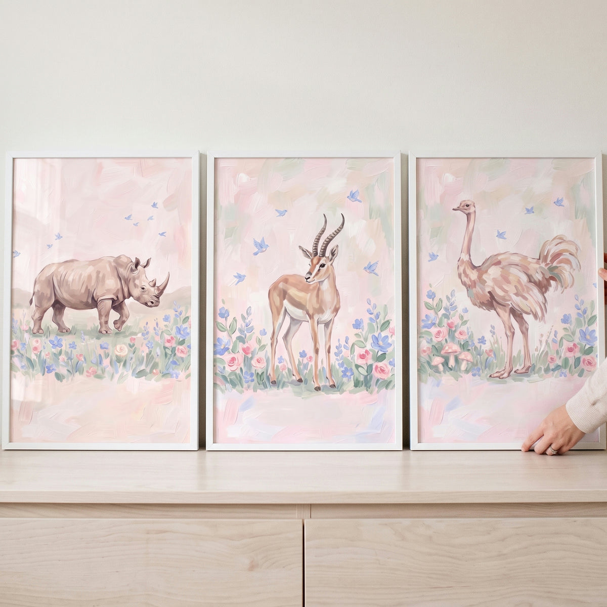 Blue bird safari animals wall art set of 3 featuring a rhino, gazelle, and ostrich in soft pink and floral tones.