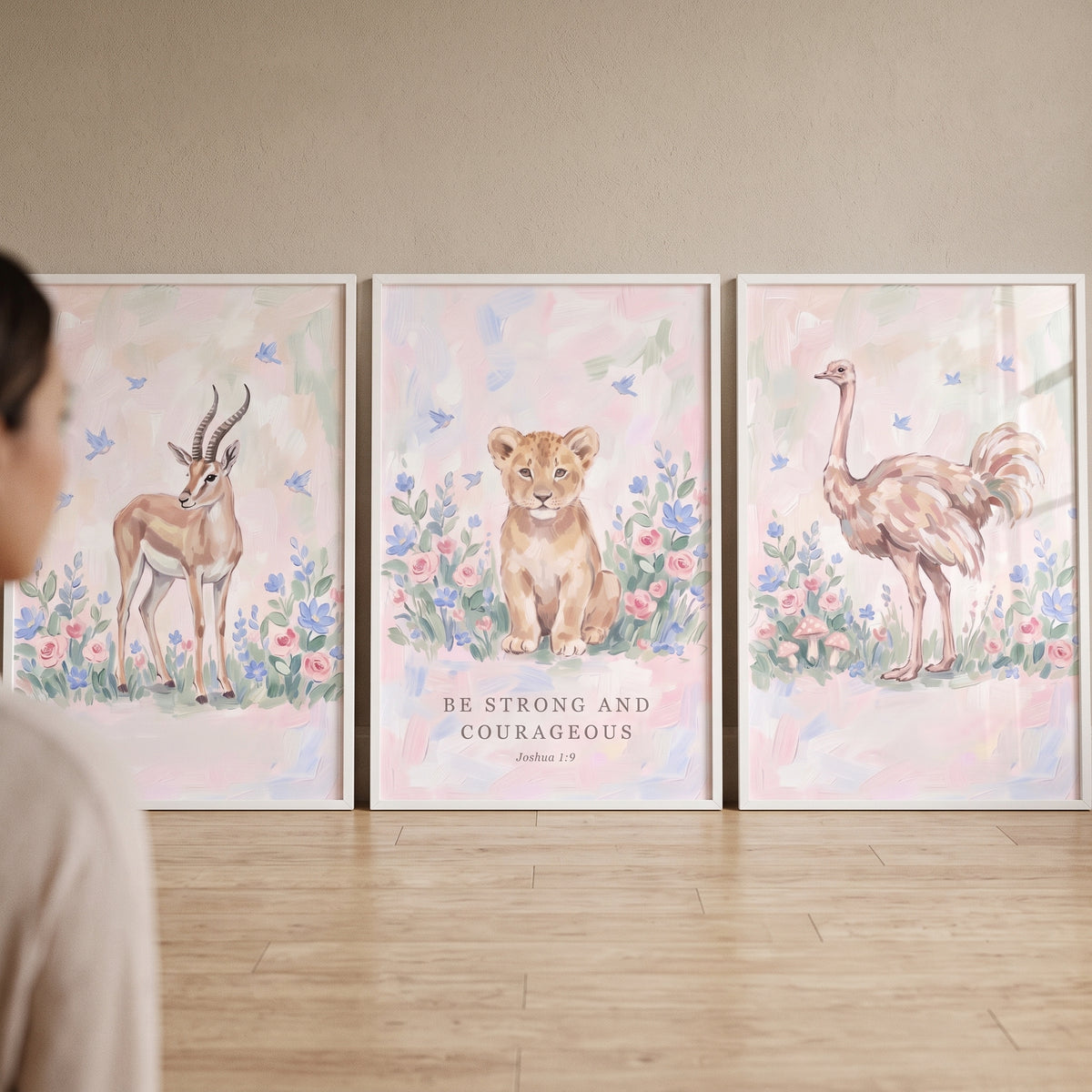 Blue bird savanna animals wall art set of 3 with a gazelle, lion cub, and ostrich in soft watercolor floral designs.