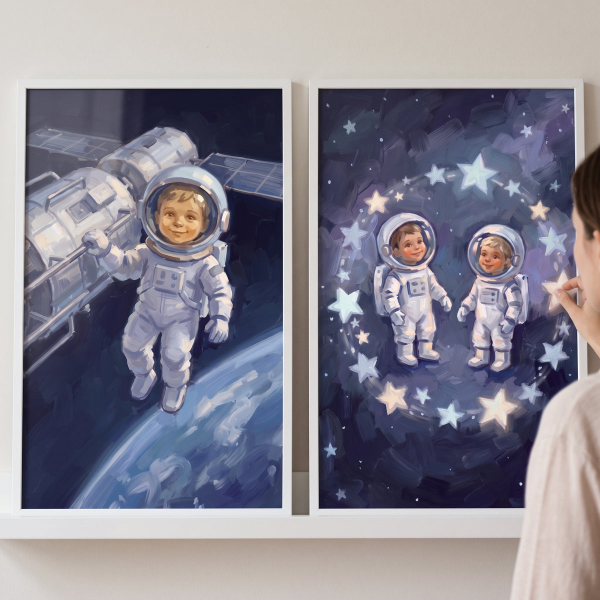 Blue cosmic baby astronaut wall art set of 2 depicts infants in space suits near a space station and glowing stars.