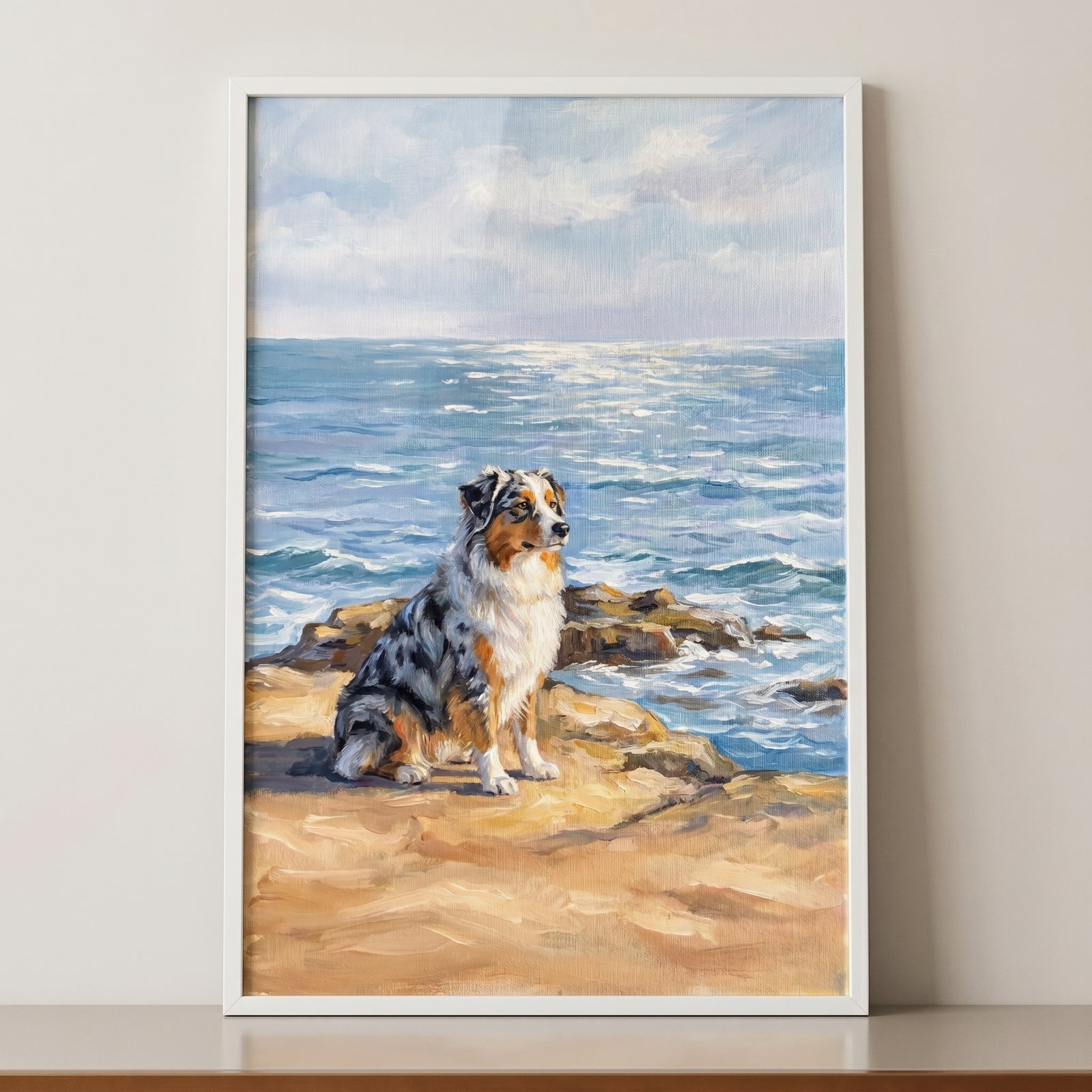 Blue merle australian shepherd dog wall art of the pet sitting on rocky cliffs near shimmering blue ocean water.