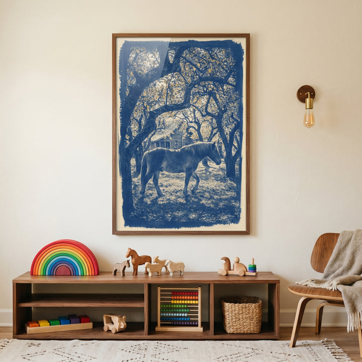 Blue orchard horse wall art above a wooden shelf with toys, an abacus, and a woven basket next to a modern wooden chair.