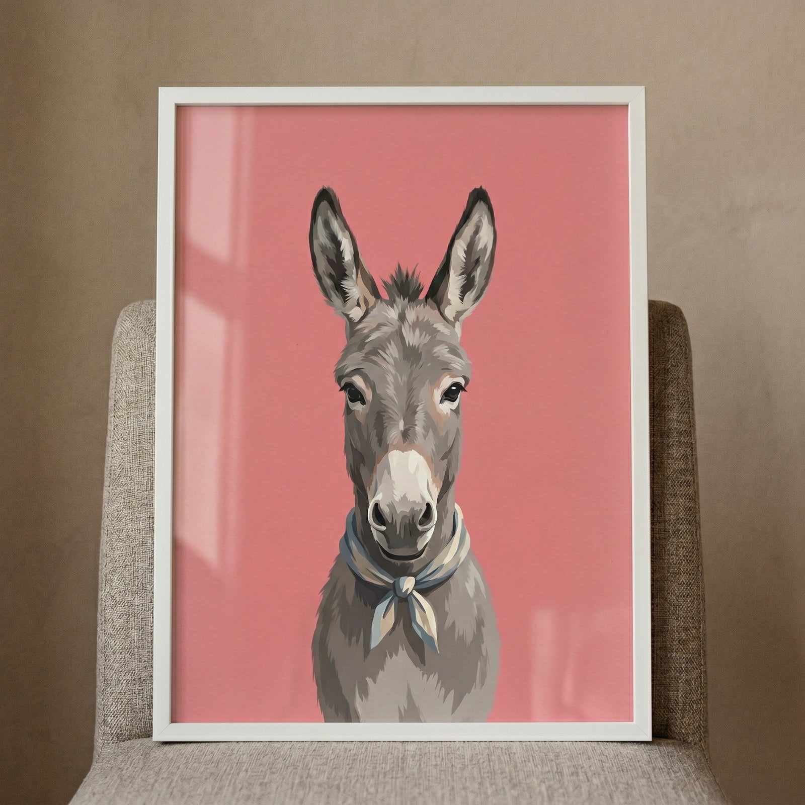 Framed blue scarf donkey wall art shows a grey donkey against a pink background, propped on a textured grey chair.