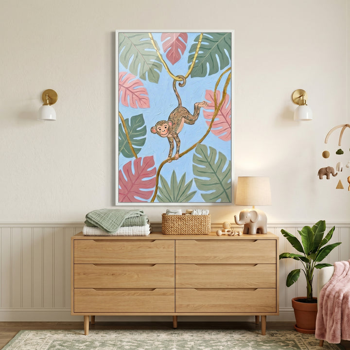 Blue tropical leaf monkey wall art hangs above a wooden dresser in a nursery with an elephant lamp and plant.