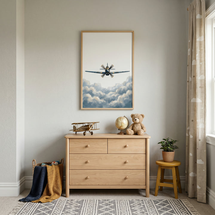 Blue vintage clouds airplane wall art hangs over a wood dresser with a toy plane, globe, and teddy bear in a nursery.