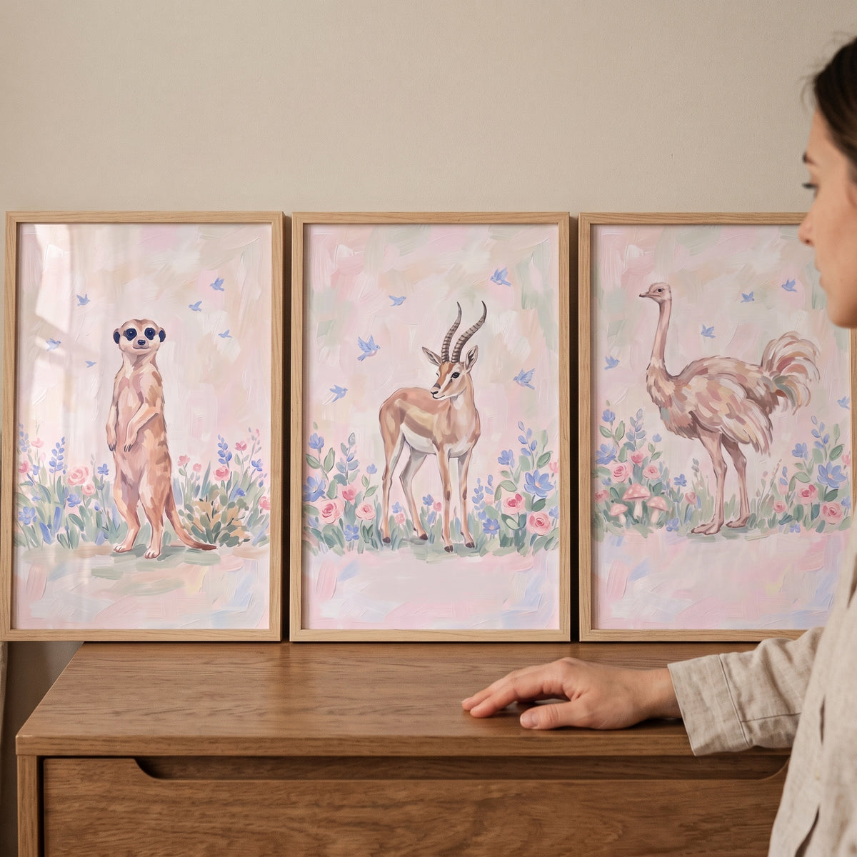 Blue wildflower safari animals wall art set of 3 featuring a meerkat, gazelle, and ostrich displayed on a wooden dresser.