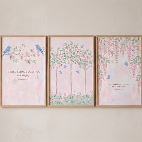 Blue winged garden animal wall art set of 3 features pink flowers and religious scriptures in light wood frames.
