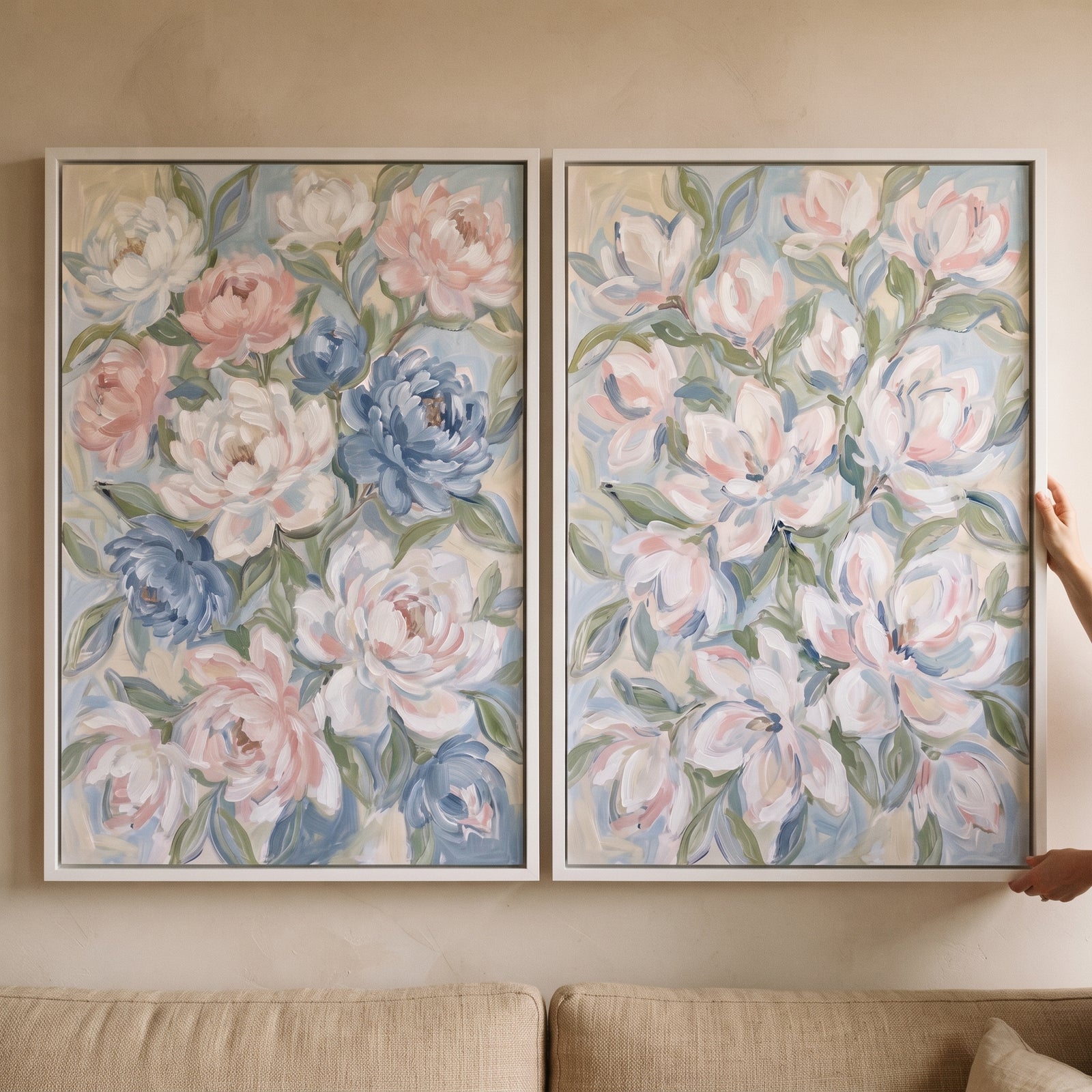 blush blue impressionist peony floral wall art set of 2 in white frames on a beige wall above a neutral sofa.