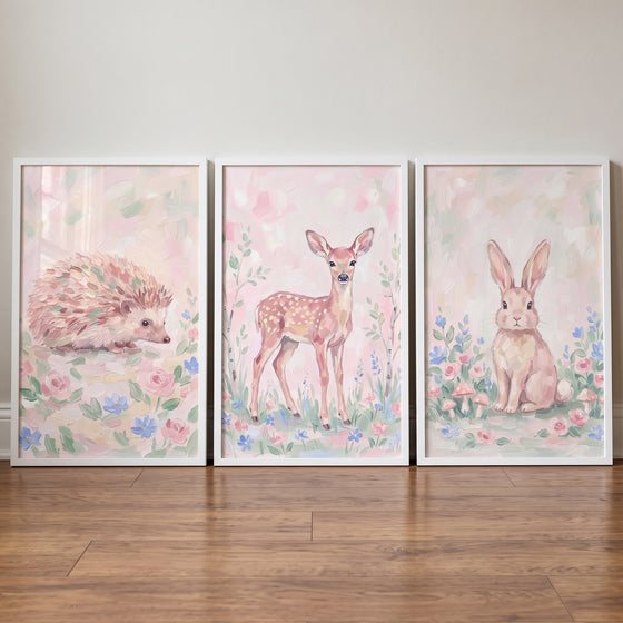 Blush bouquet woodland animals wall art set of 3 featuring a hedgehog, deer, and rabbit in soft floral settings.