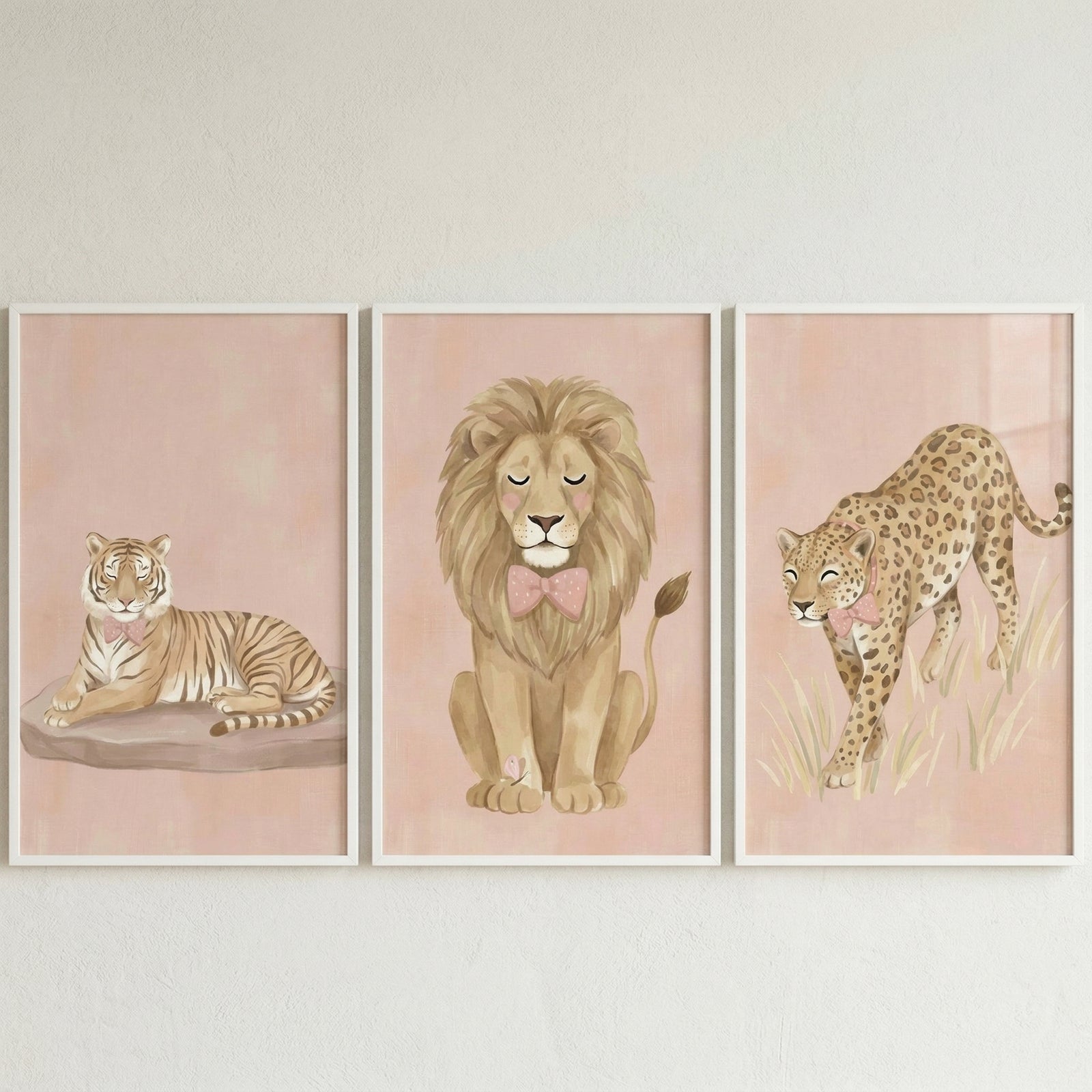 A set of three vertical framed illustrations features stylized big cats in a gentle, soft-focus style. Each animal is depicted in a whimsical manner, suitable for a nursery or child's room decoration.
