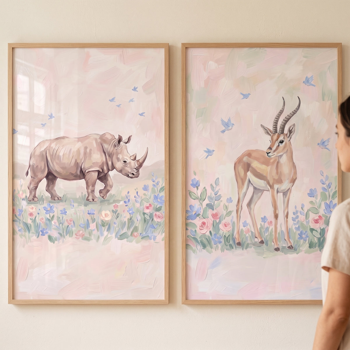 Blush meadow safari animals wall art set of 2 featuring a rhino and gazelle in soft floral fields with wood frames.