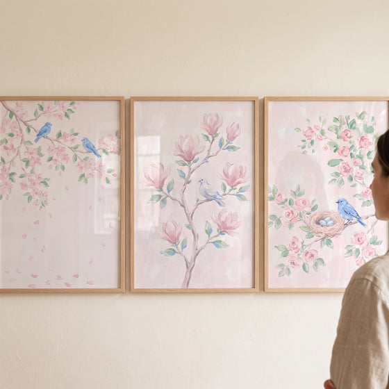 Blush pink blue bird wall art set of 3 featuring soft floral illustrations, songbirds, and a nest in wood frames.