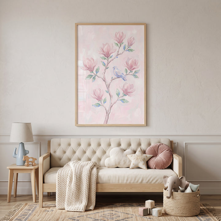 Blush pink magnolia floral wall art hangs above a neutral tufted sofa with plush pillows and a woven toy basket.