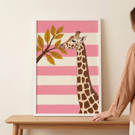Blush pink striped giraffe wall art showing a giraffe reaching for golden leaves against horizontal stripes.