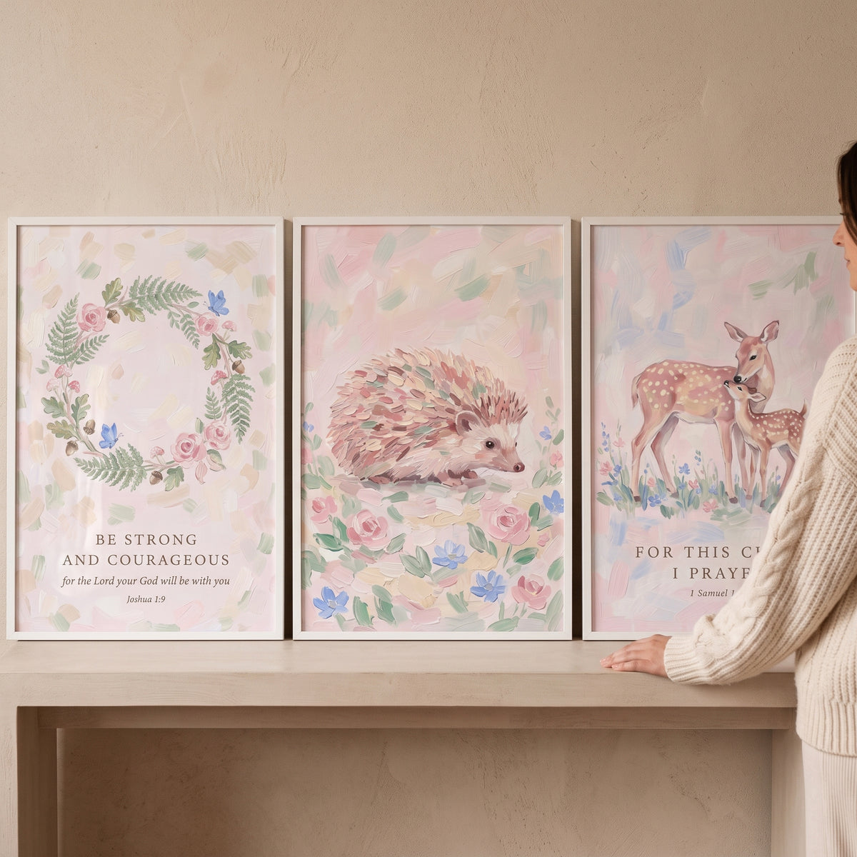 Blush watercolor forest animals wall art set of 3 featuring a floral wreath, hedgehog, and deer with scripture verses.