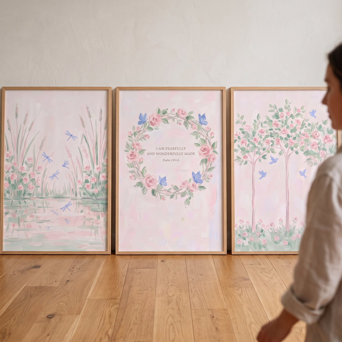 Blush watercolor rose garden wall art set of 3 featuring a wreath, dragonflies, and rose trees in light wood frames.