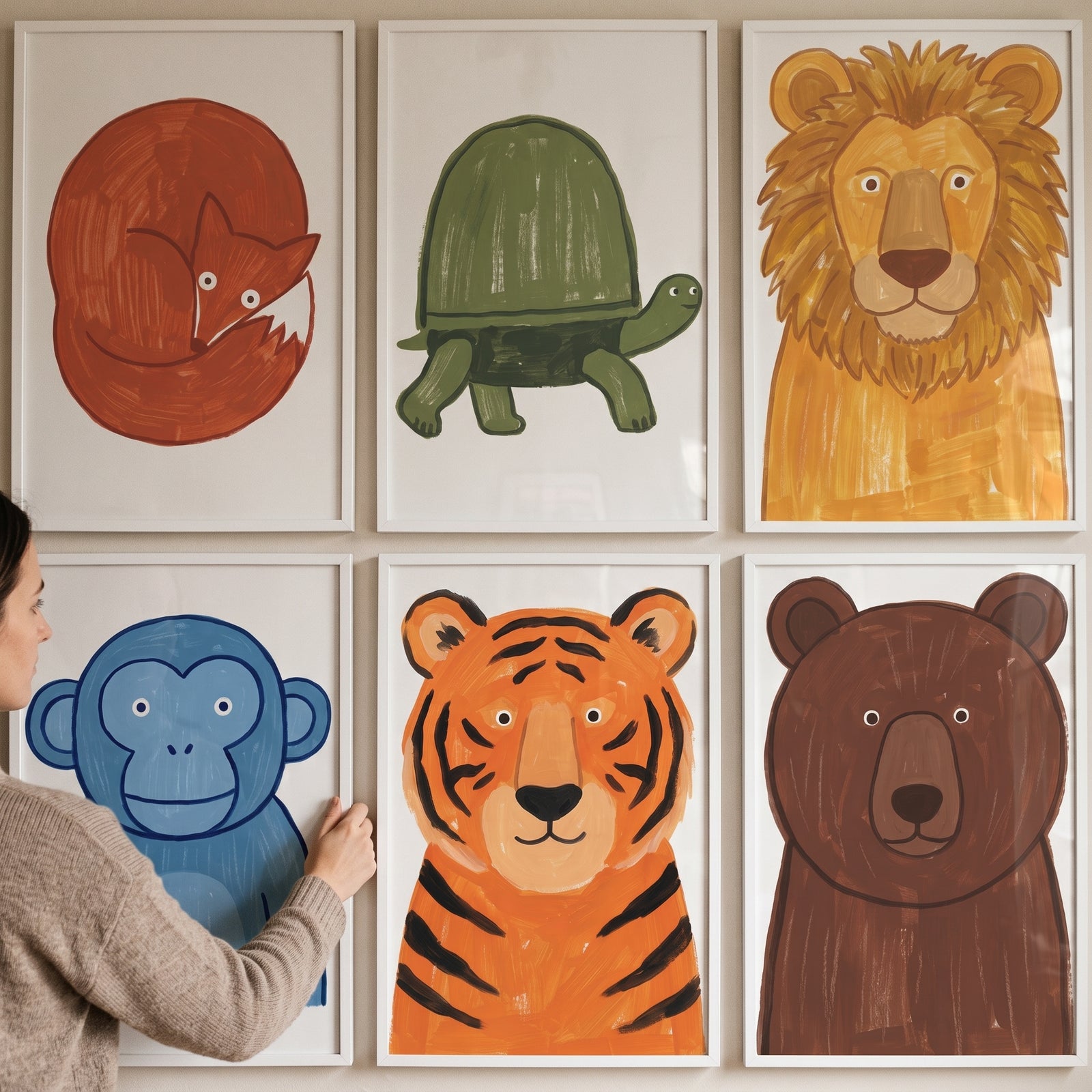 A person hangs a bold texture safari animals wall art set of 6 featuring a fox, turtle, lion, monkey, tiger, and bear.