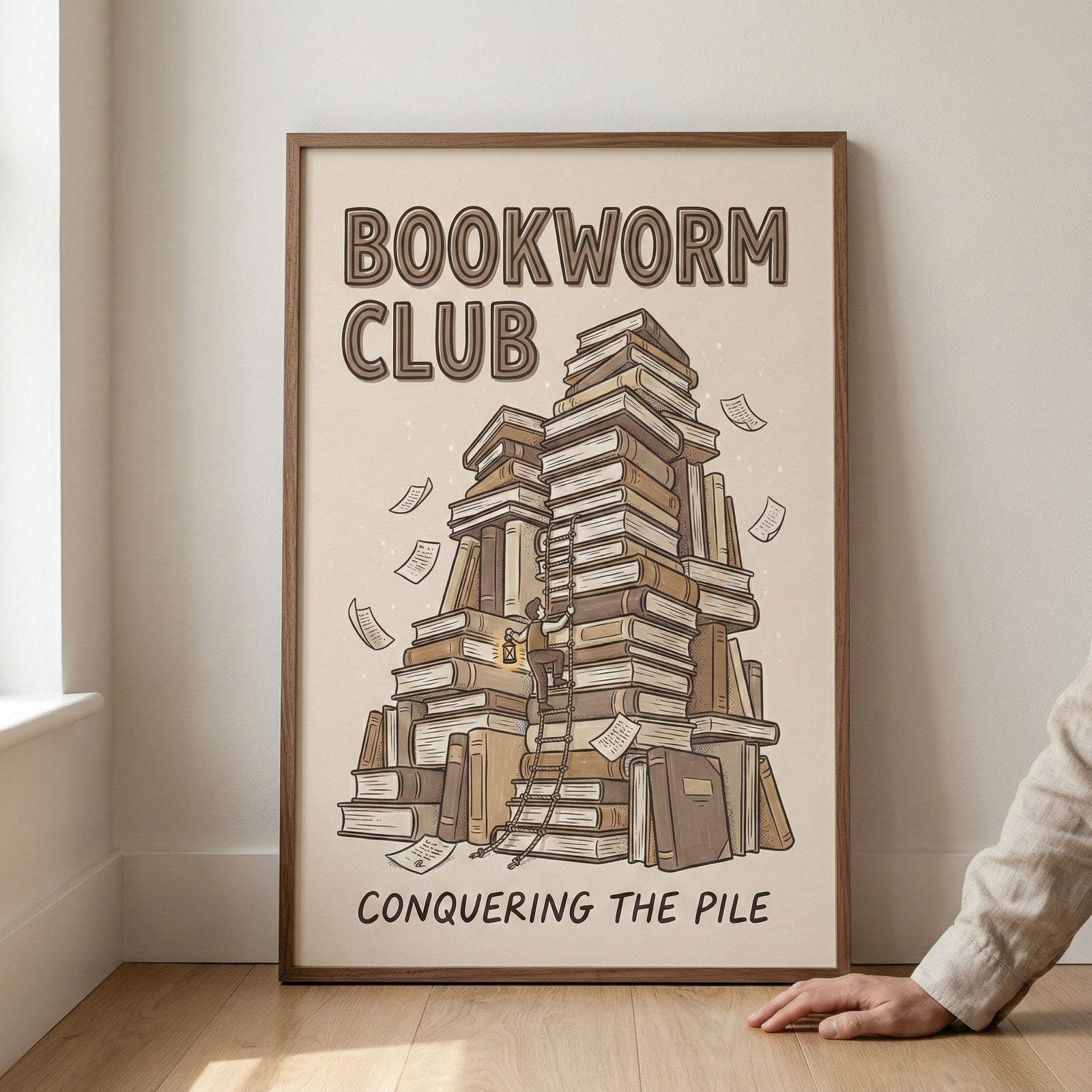 Illustrated poster featuring towering stacks of books with the title “Bookworm Club” and the phrase “Conquering the Pile,” showing a tiny figure climbing a ladder with a book and lantern in hand.