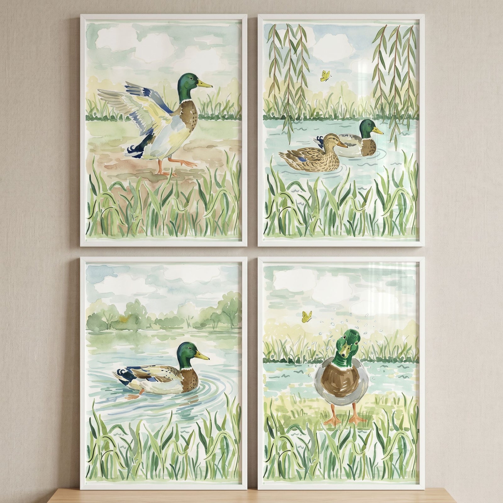 Botanical mallard duck wall art set of 4 features watercolor ducks in natural pond settings with reeds and willow trees.