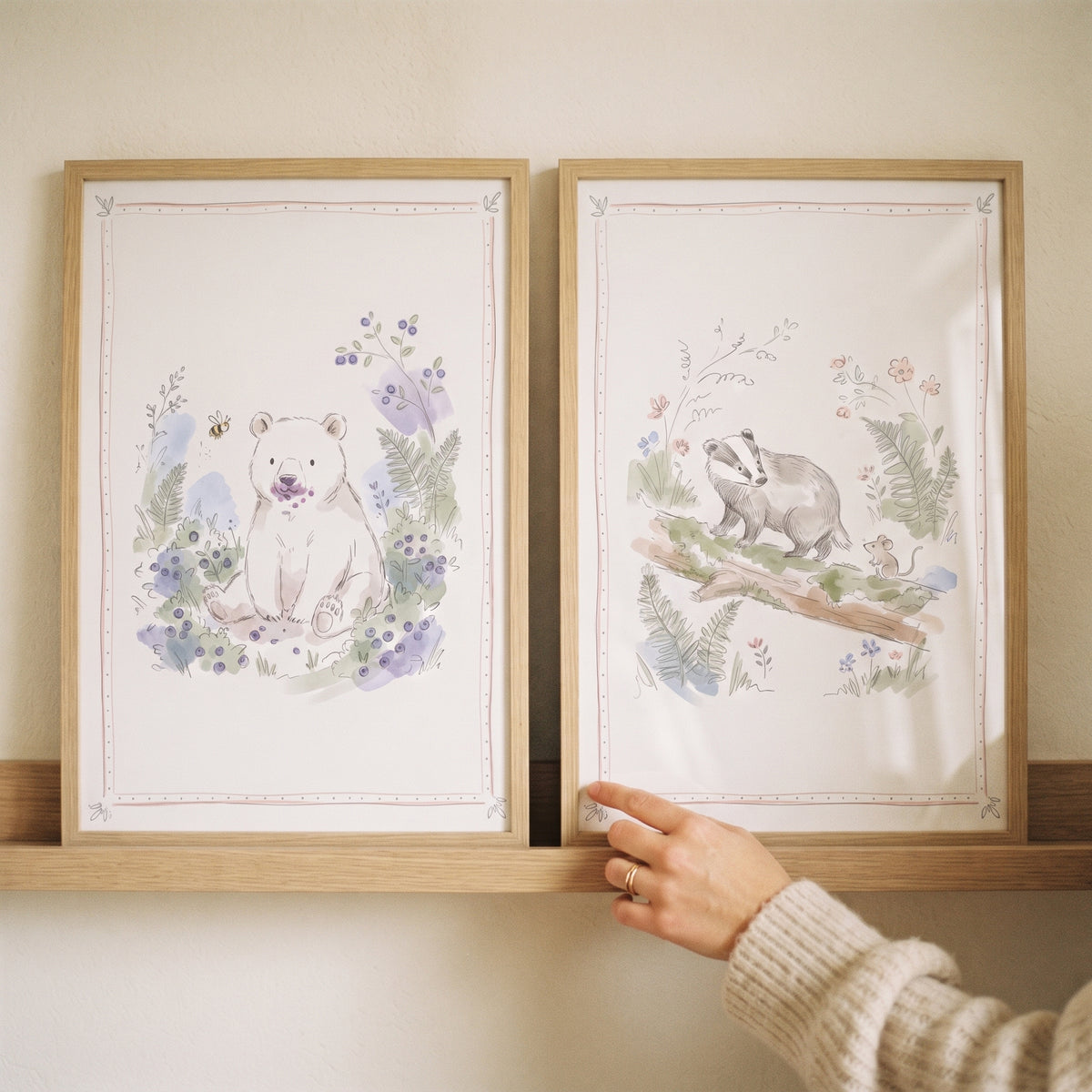 Watercolor bear and badger botanical storybook woodland animal wall art set of 2 in wood frames on a shelf.