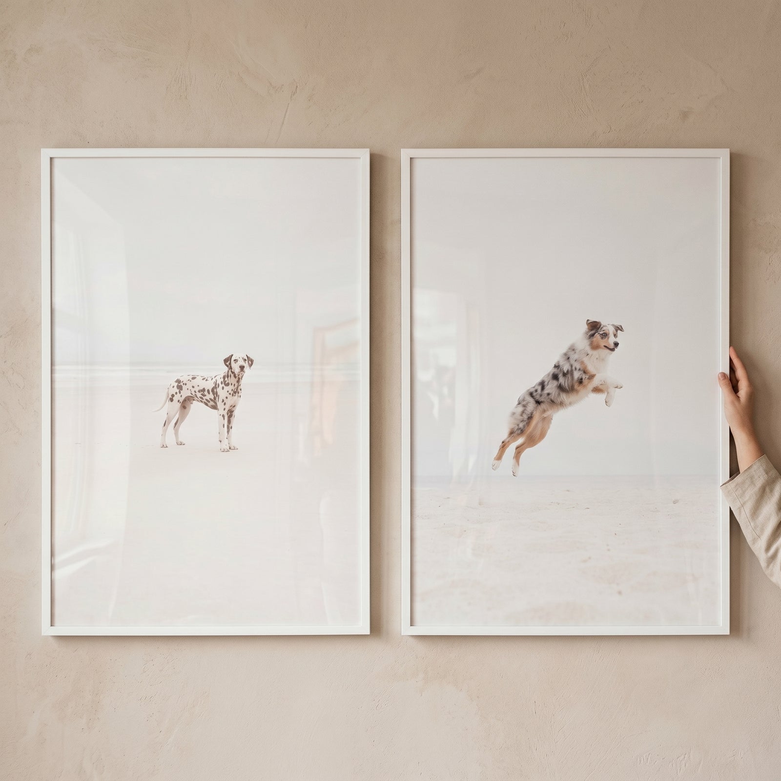 Bright minimalist coastal dog wall art set of 2 featuring a Dalmatian standing and a shepherd jumping on a sandy beach.