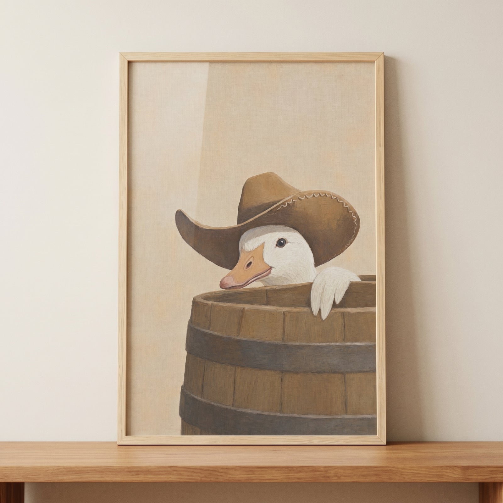Framed brown cowboy hat goose wall art shows a white goose peeking from a wooden barrel above a wood shelf.