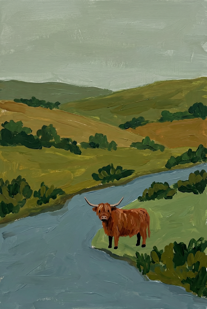 Brown shaggy highland cow wall art shows a cow by a blue river in a landscape of green hills under an overcast sky.