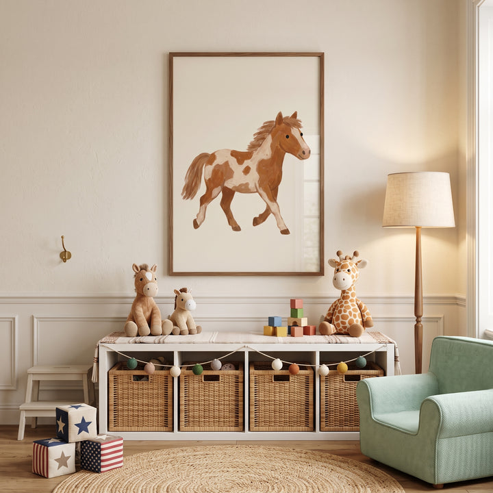 Brown white spotted pony wall art in a nursery with wicker baskets, plush animals, a floor lamp, and a green armchair.