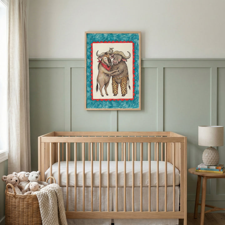 Nursery room with a wooden crib and soft toys in a basket, featuring a framed illustration above the crib of a hugging buffalo and wildebeest. The playful animal art adds a warm, whimsical touch to the soft green-paneled wall.