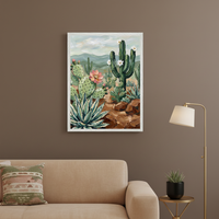 Living room with a beige sofa against a brown wall. A framed painterly desert landscape, featuring saguaro, prickly pear, agave, and flowers, hangs above the sofa. A gold floor lamp and side table with a succulent are to the right.