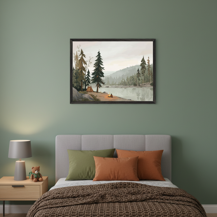Bedroom with a grey bed and a light wood nightstand. A framed illustration of a lakeside camping scene with pine trees, mountains, a tent, and a person by a campfire hangs centered above the bed.