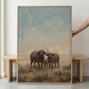 The illustration is rendered in a soft, impressionistic style with visible, textured brushwork, using a palette of earthy browns and tans for the animals and landscape, and muted blues and grays for the expansive, hazy sky. The artwork is enclosed in a minimalist, light-toned