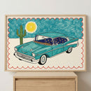 Colorful framed illustration of a vintage teal car with starry night curtains and leopard print accents, set against a desert background with a cactus and sun, bordered by a red scalloped edge.
