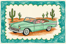 Illustrated drawing of a mint green vintage convertible car parked in a desert landscape with tall green cacti in the background. The car is filled with patterned pillows, including red stars and leopard print, and the scene is framed with a playful teal and scalloped border.