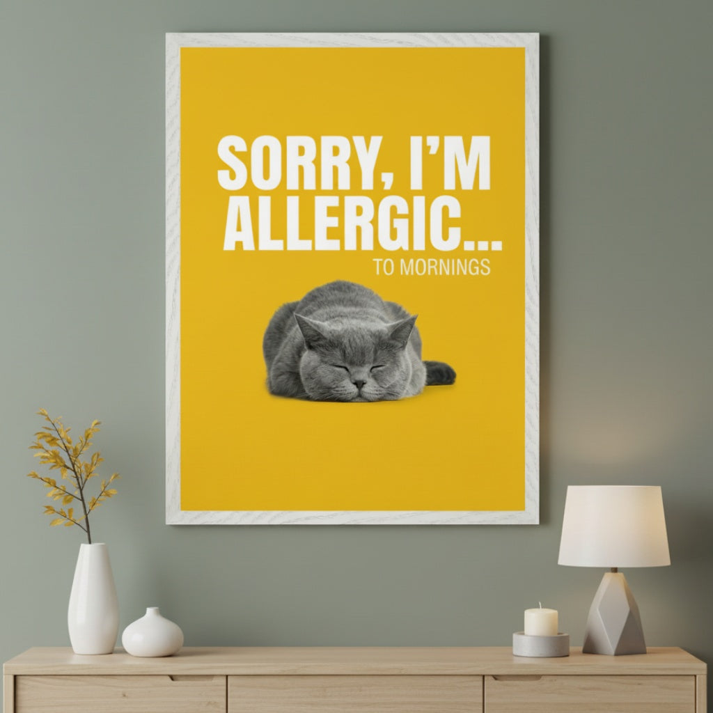 Modern room with a light wood dresser. A large framed yellow poster hangs above the dresser, featuring "SORRY, I'M ALLERGIC... TO MORNINGS" in white text and a sleeping grey cat.