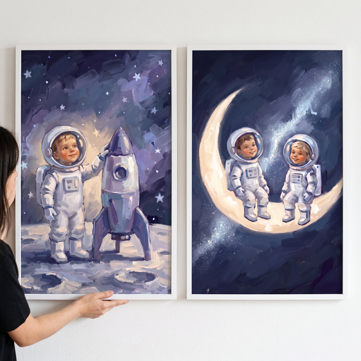 Celestial theme baby astronaut wall art set of 2 featuring children in space suits with a rocket and on a crescent moon.
