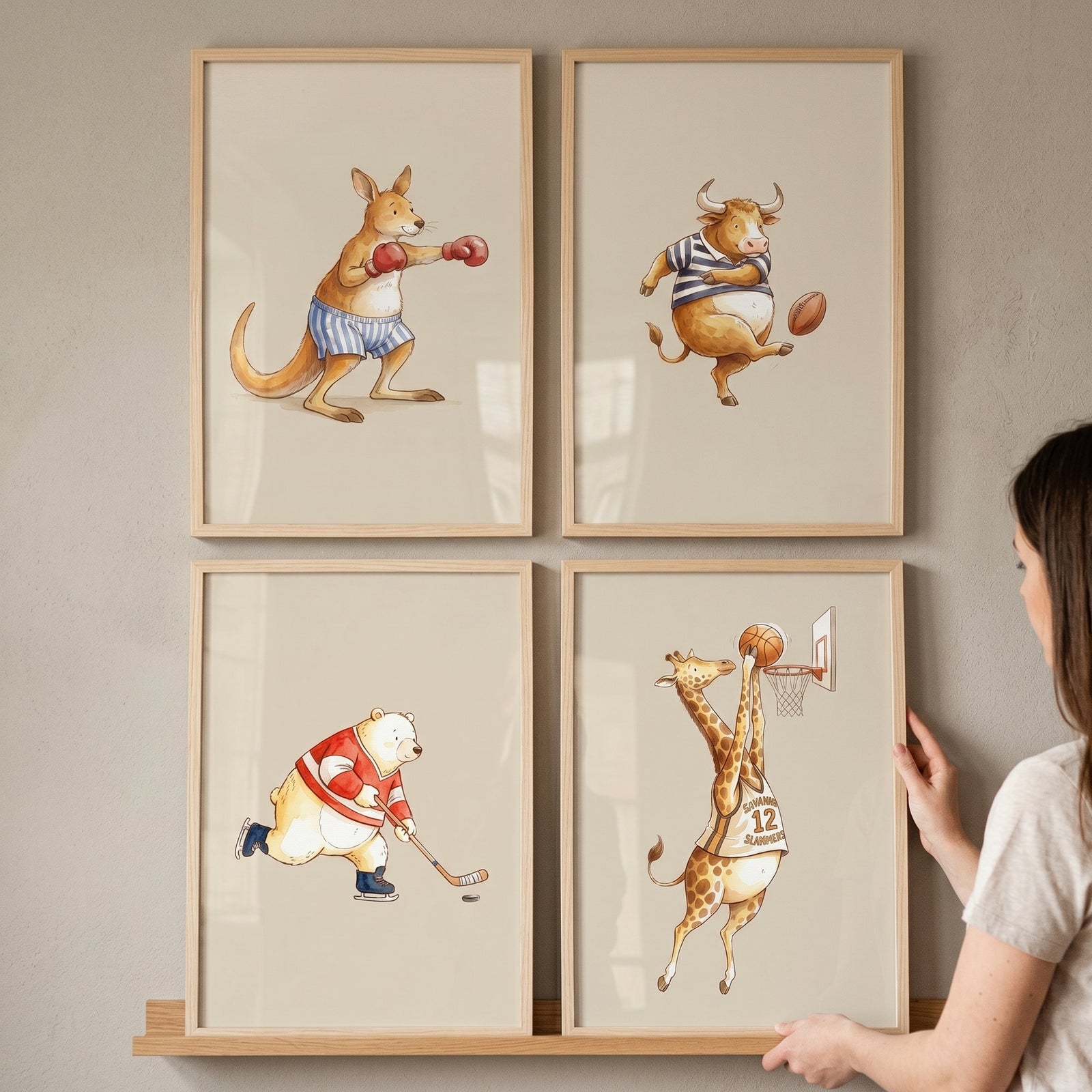 Charming watercolor sports animal wall art set of 4 with a boxing kangaroo, bull, hockey bear, and basketball giraffe.