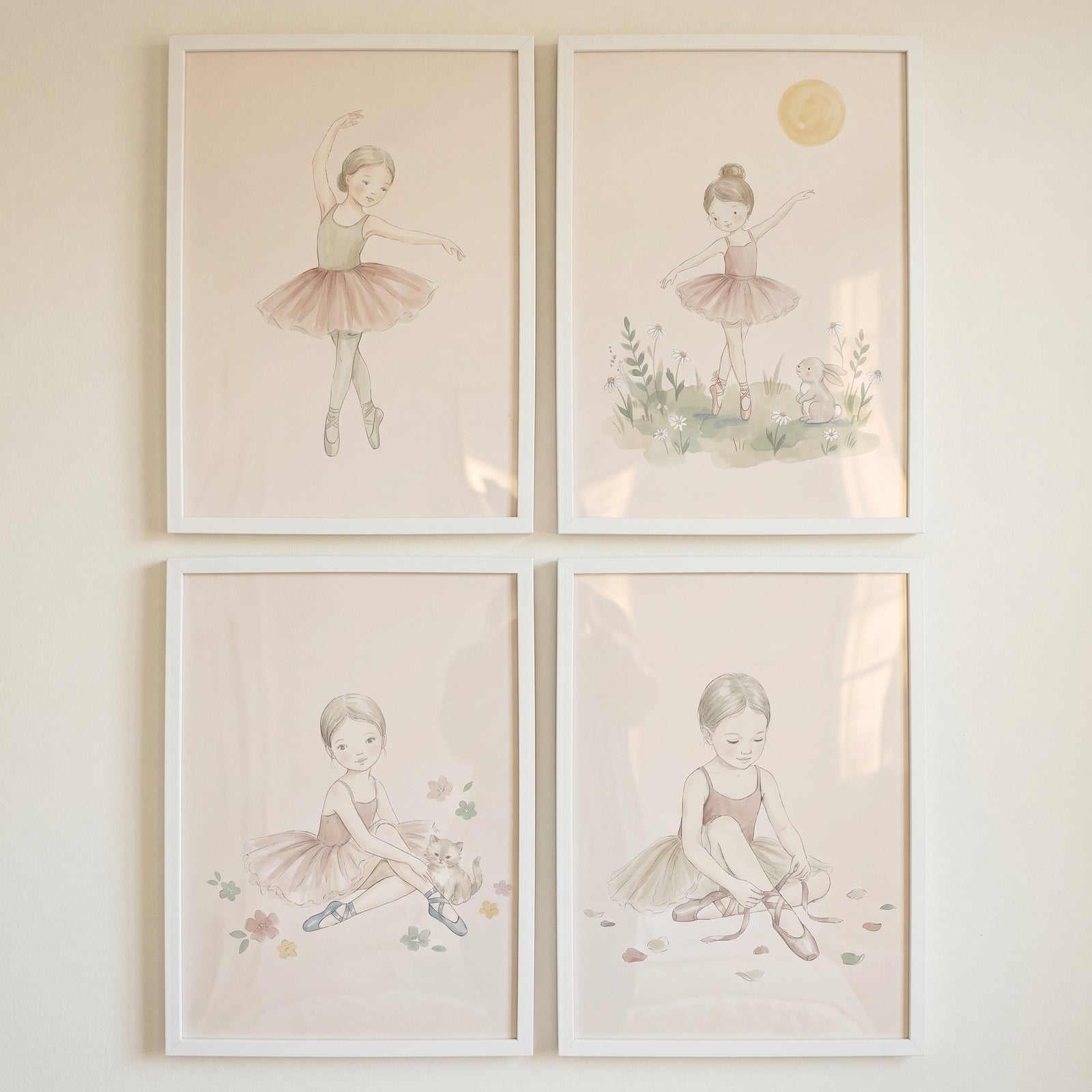 Framed chic pastel watercolor ballerina artwork set of 4 shows girls dancing, sitting with animals, and tying slippers.
