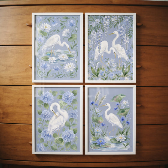 Chinoiserie botanical white heron bird wall art set of 4, featuring blue florals and white frames on a wood dresser.