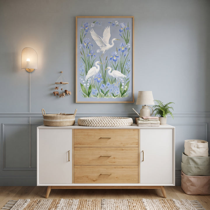 Nursery room with chinoiserie style white heron bird wall art above a white and wood dresser with a woven changing mat.