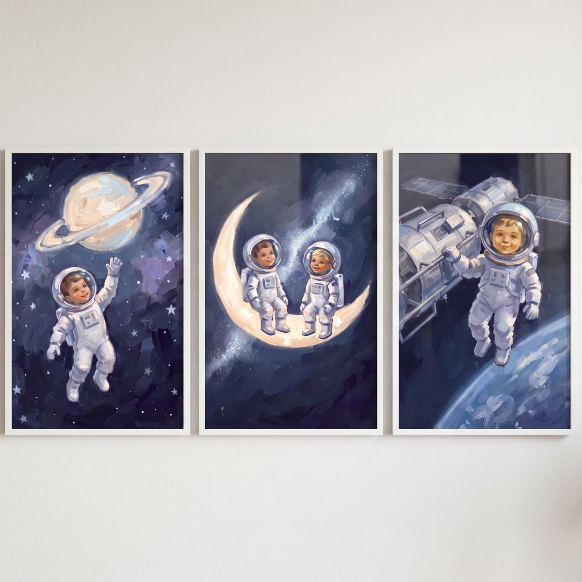 Classic navy baby astronaut wall art set of 3 featuring infants in space suits with a ringed planet, moon, and satellite.