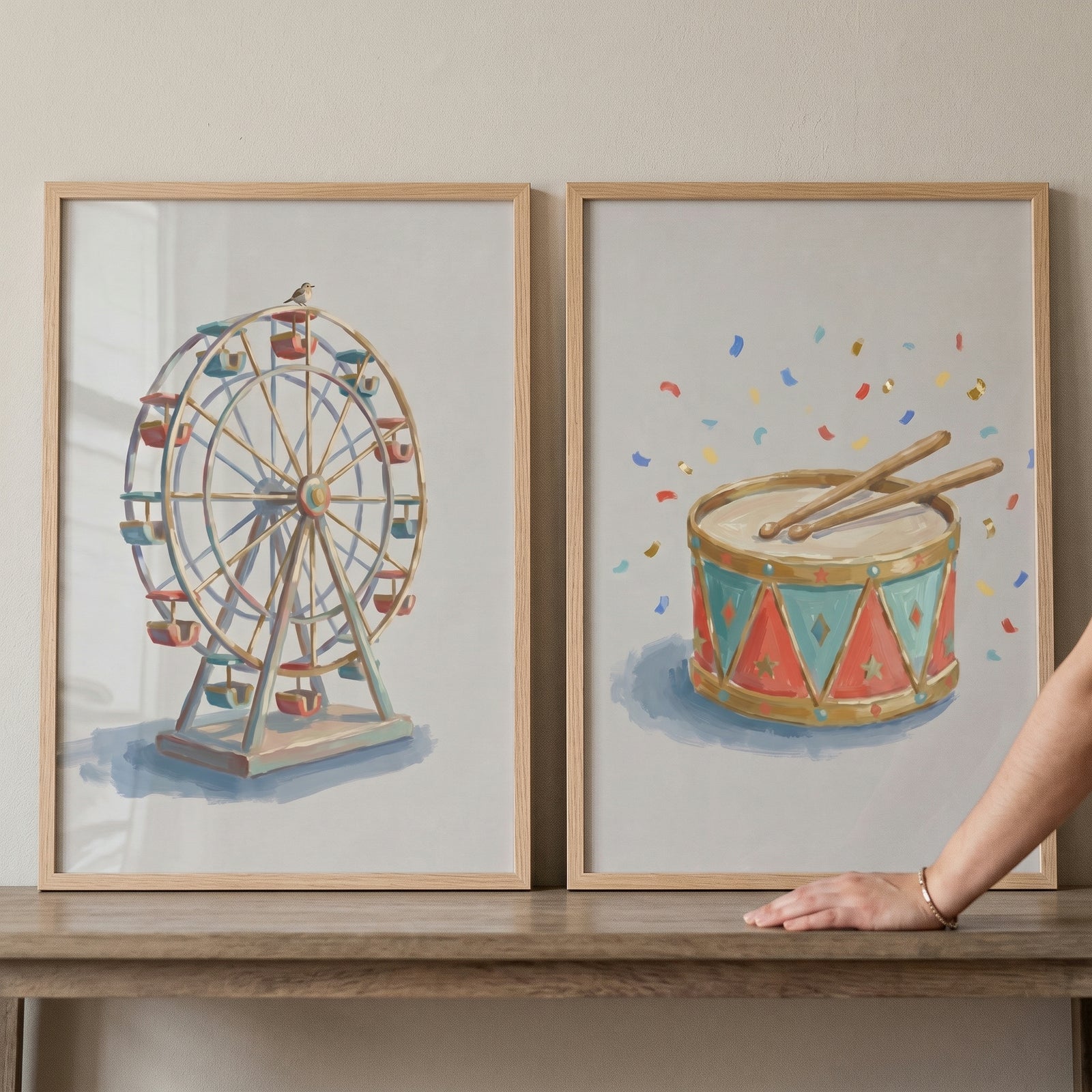 Classic watercolor carnival wall art set of 2 features a Ferris wheel and a circus drum in light wood frames on a shelf.