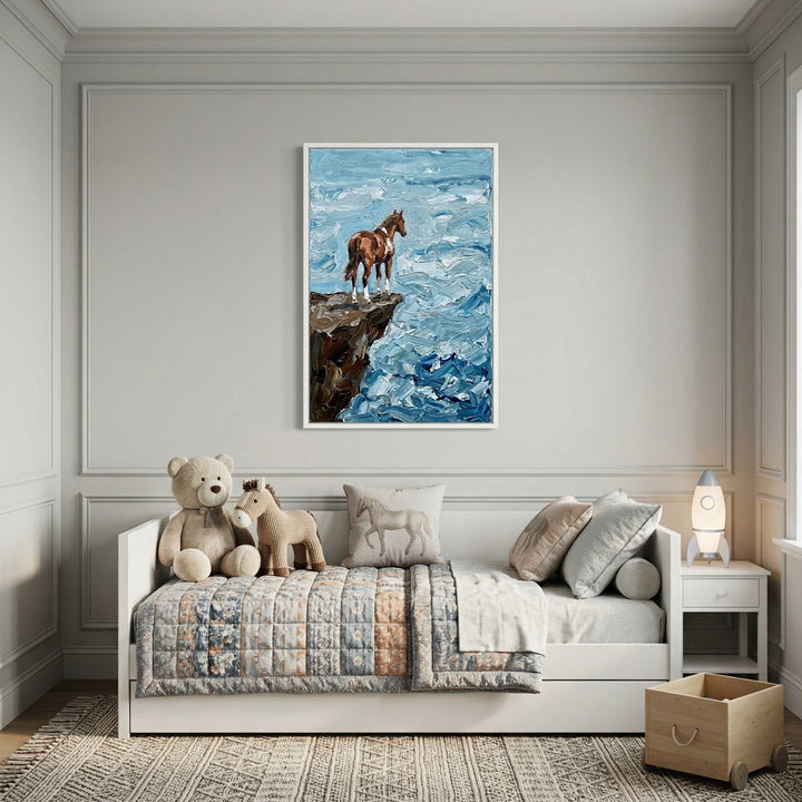 A serene, neutrally-toned child's bedroom features elegant grey walls with classic molding. Centered on the wall above a white daybed is a framed piece of textured wall art depicting a brown and white horse standing on a dark, rocky precipice above a churning blue sea, created with thick, tactile strokes. 