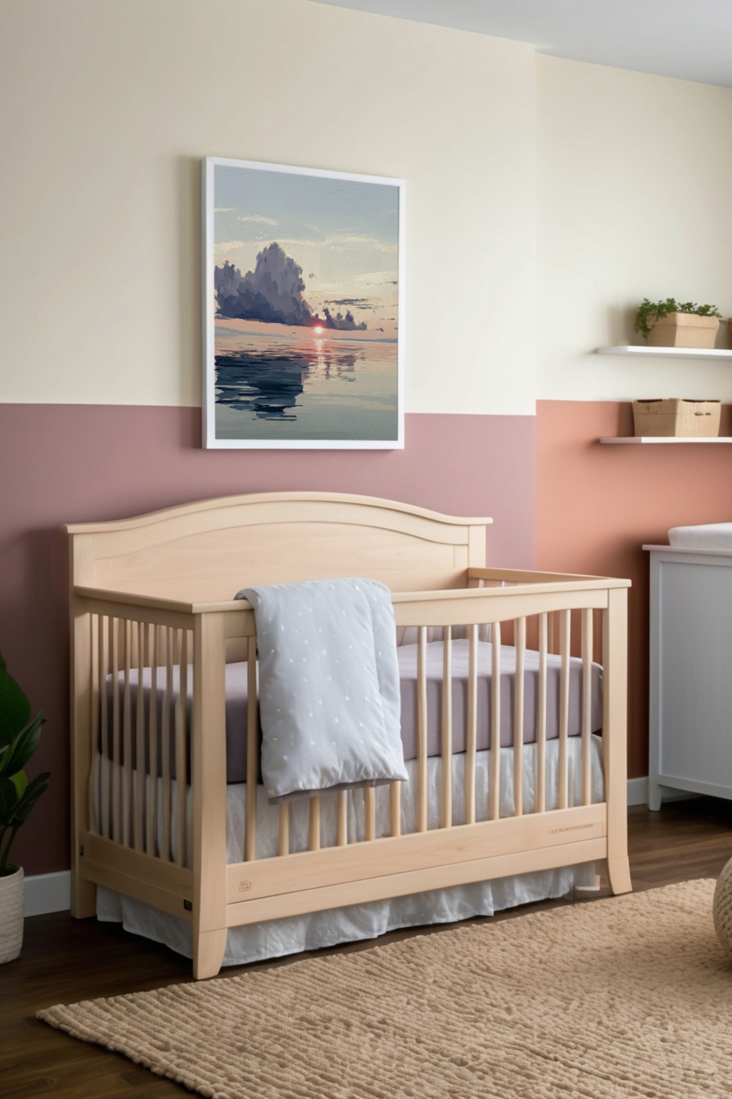 Calming nursery room featuring a wooden crib with a soft blue blanket draped over the side. Above the crib hangs a framed painting of a peaceful sunrise over a calm ocean, complementing the room's soothing pastel decor.
