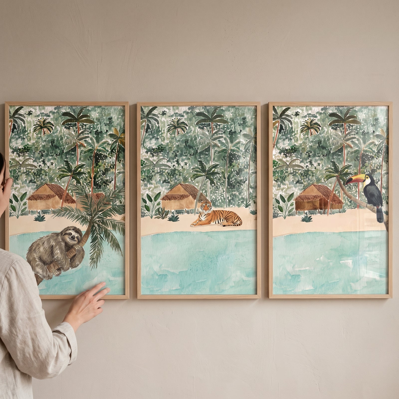 Coastal beach jungle animals wall art set of 3 featuring a sloth, tiger, and toucan in tropical landscapes.