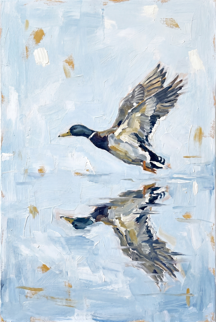 Coastal lakehouse style mallard duck artwork with a bird in flight and its reflection on textured light blue water.