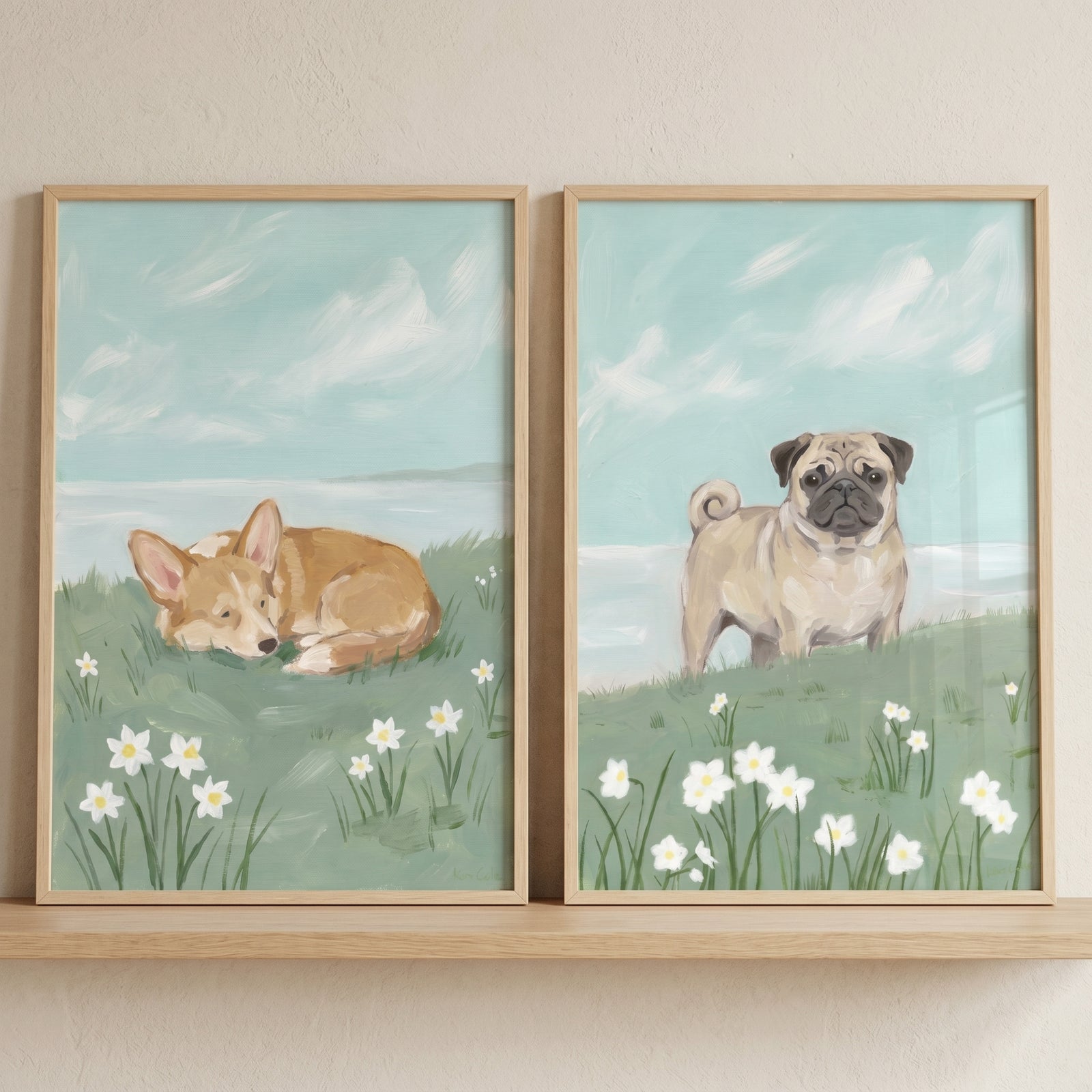 Coastal narcissus meadow dogs wall art set of 2 showing a corgi and pug in a field of white flowers under a light blue sky.