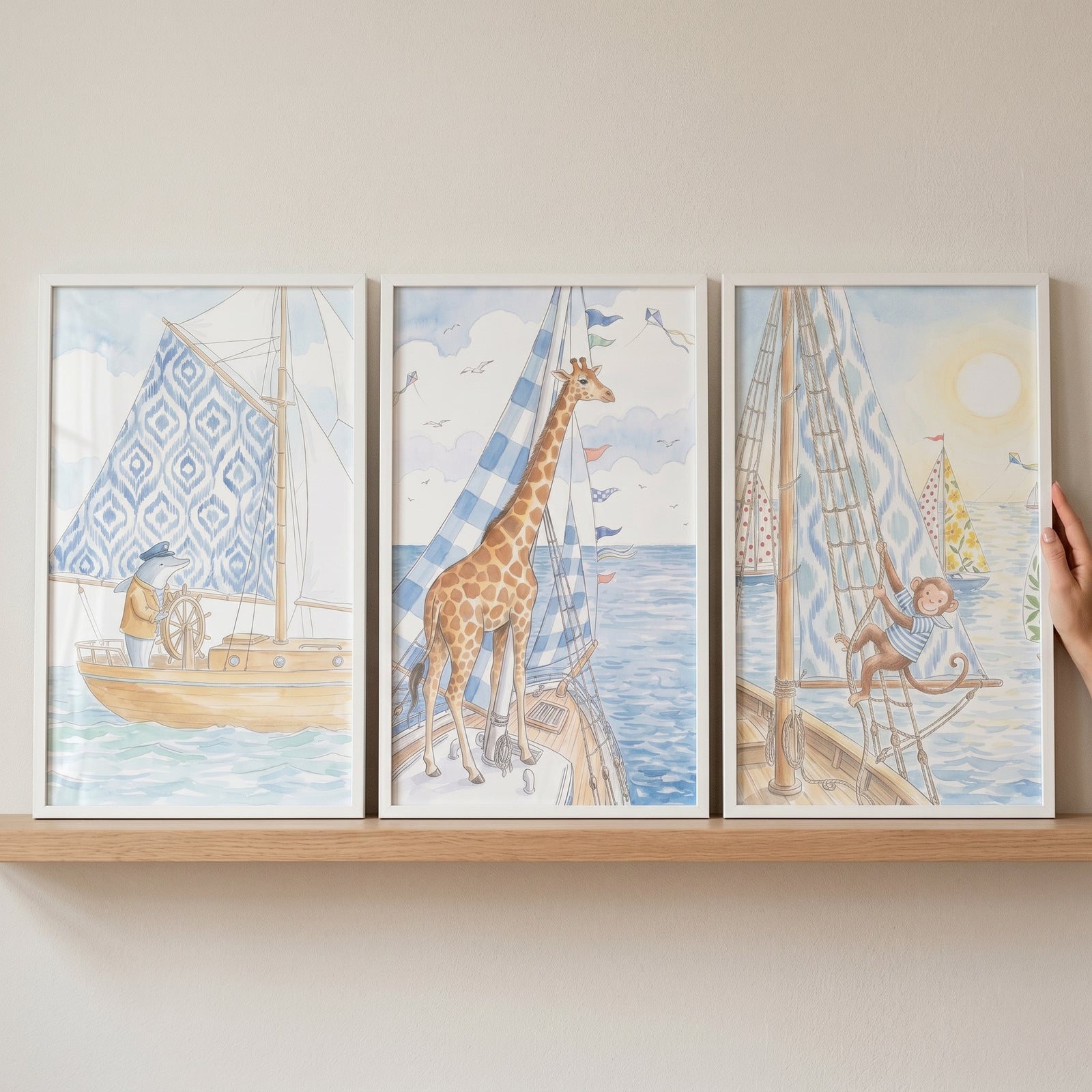Coastal sailing animals wall art set of 3 depicts a whale, giraffe, and monkey on sailboats in soft watercolor tones.