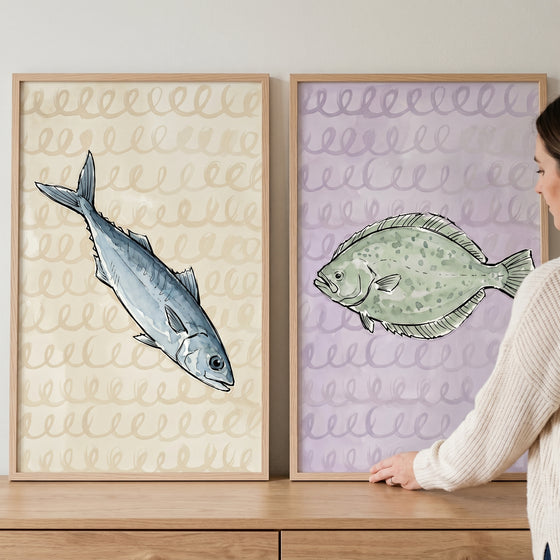 Coastal sketchy watercolor fish wall art set of 2 featuring blue and green fish prints in light wood frames.