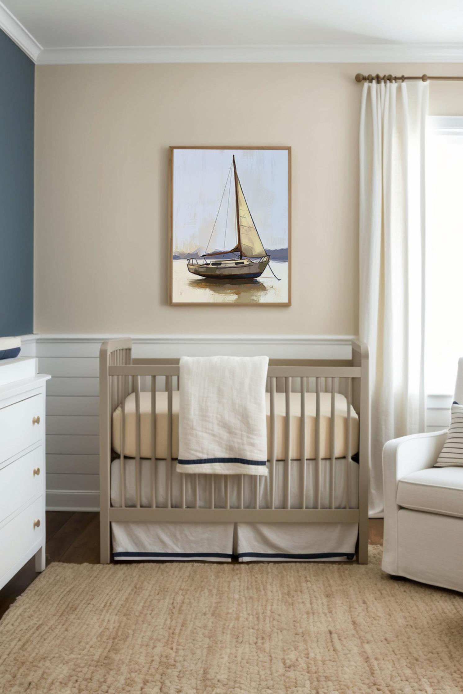 Welcoming nursery styled in warm, neutral tones of beige, cream, and navy accents, featuring a classic crib and soft textured rug. A framed painting above the crib showcases a sailboat gently anchored on calm waters, reinforcing the room's soothing nautical theme.