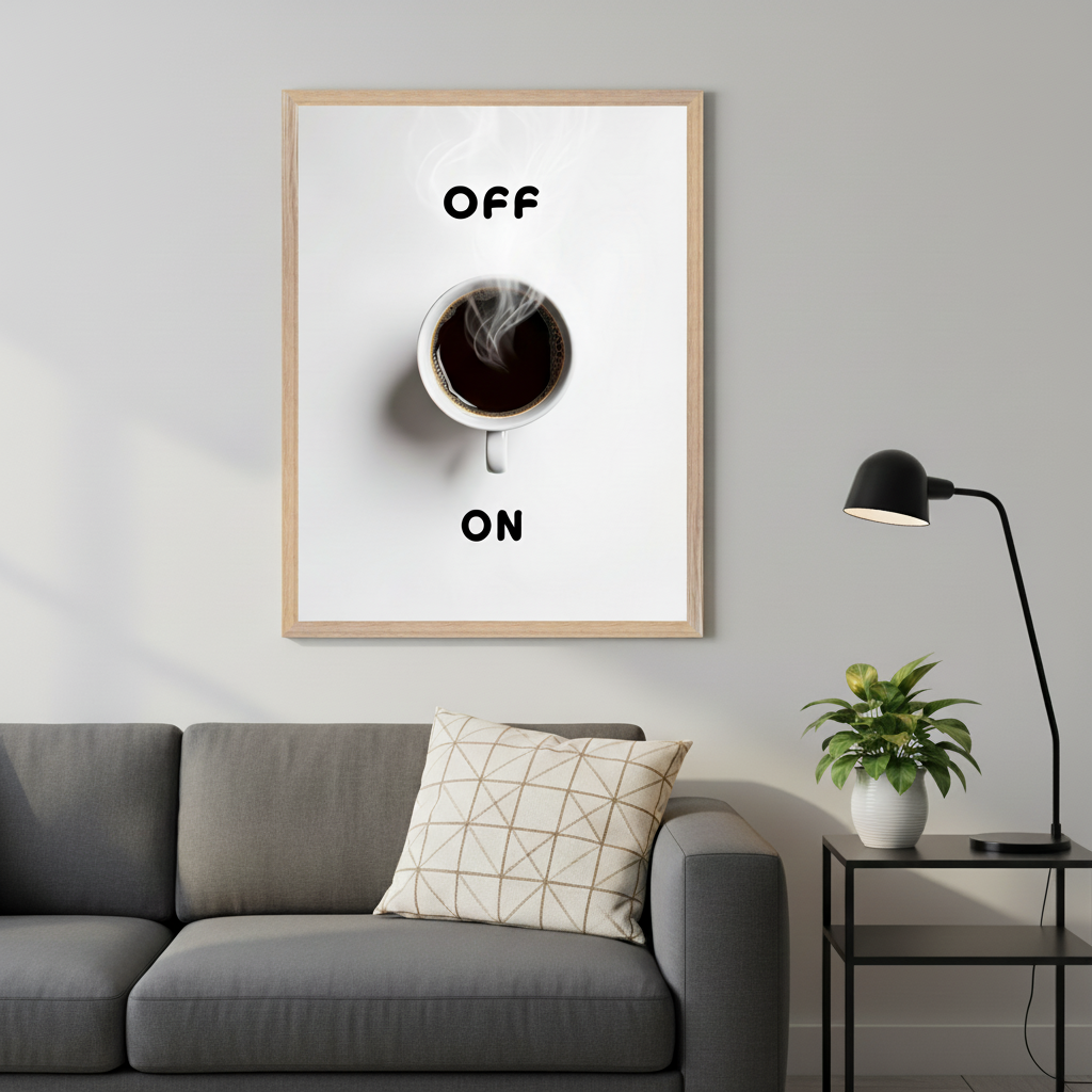 Modern living room with a grey sofa and a black side table. Above the sofa, a framed print shows a white coffee cup with "OFF" above it and "ON" below it, simulating a power switch.